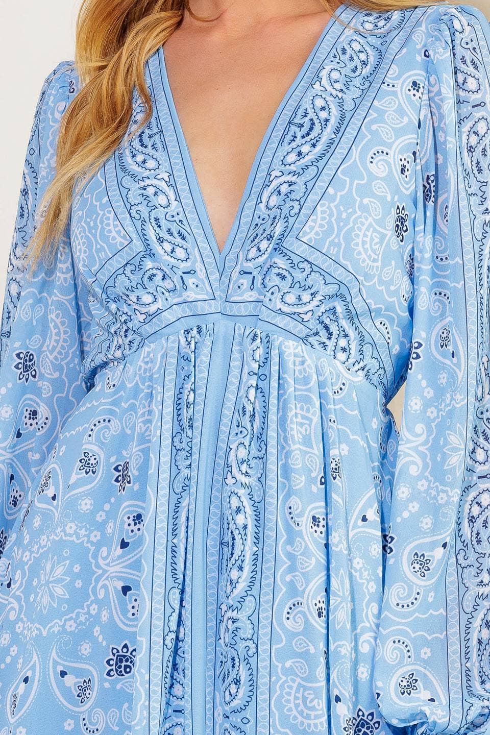 Blue paisley dress with long sleeves and a deep neckline.
