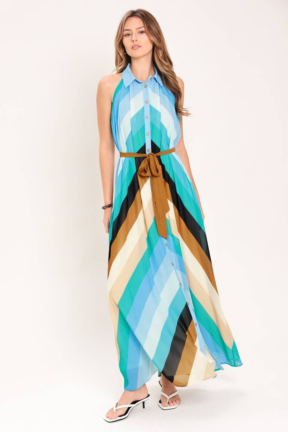 Woman wearing a colorful striped dress on a white background