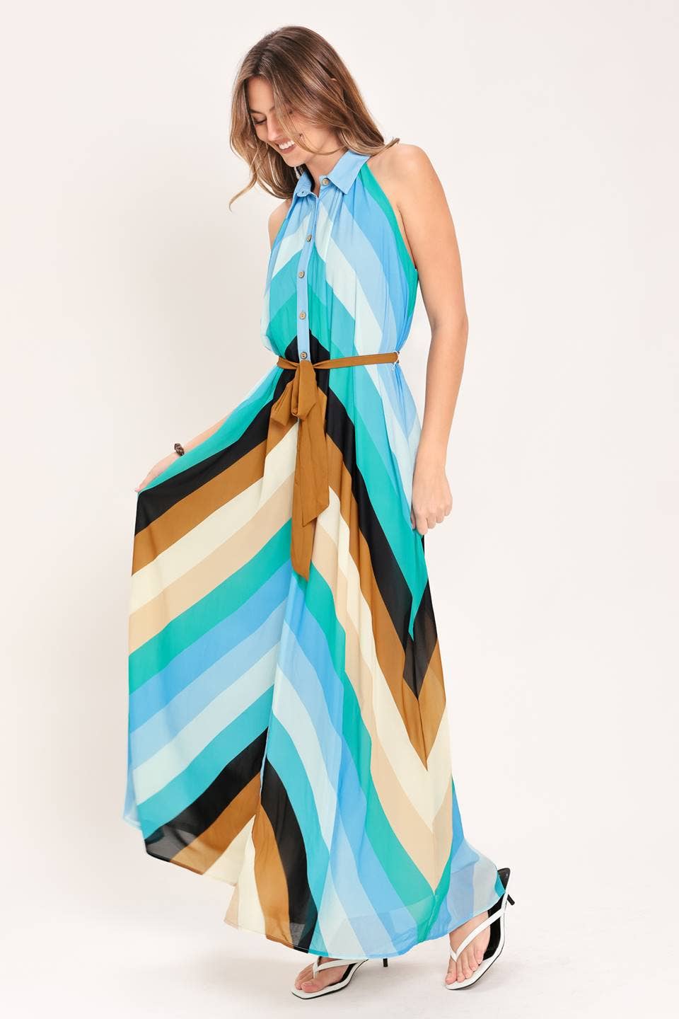 Woman wearing a colorful striped dress on a white background