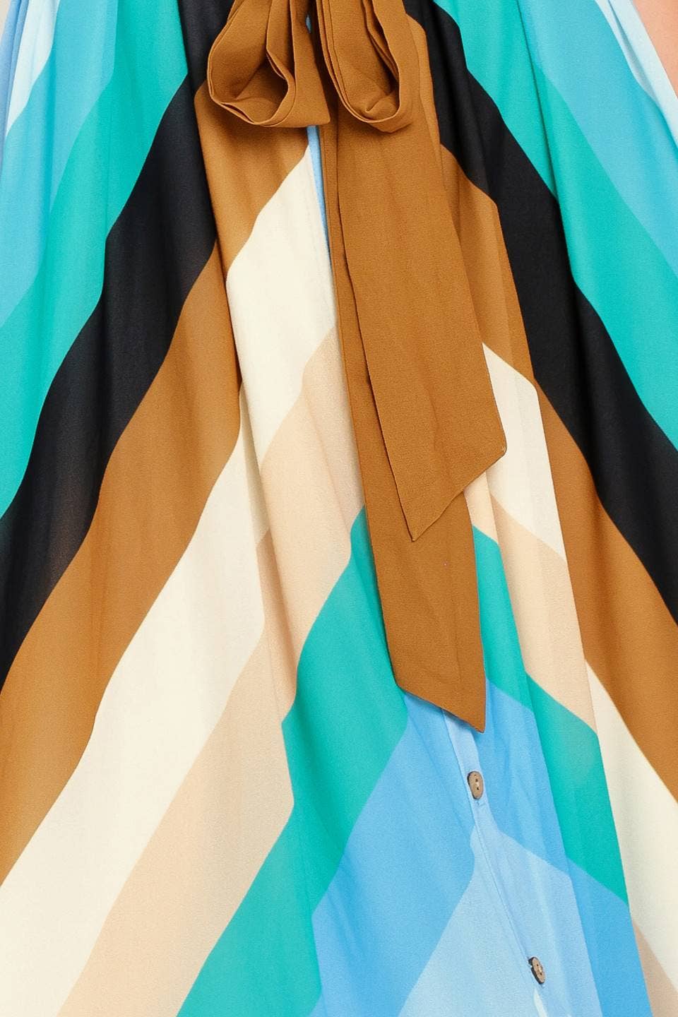 Colorful striped fabric with a brown ribbon and button details