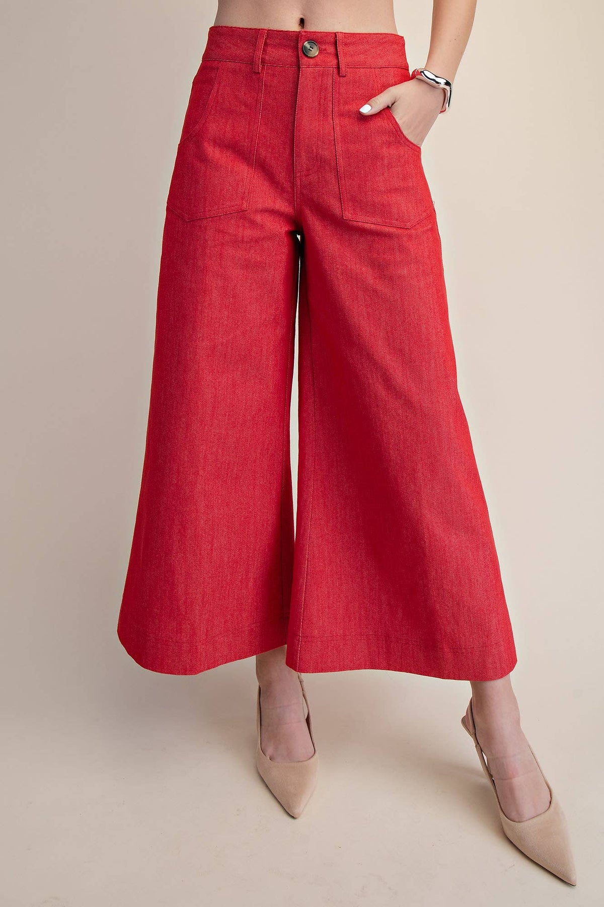 Red wide-leg pants worn by a person on a beige background