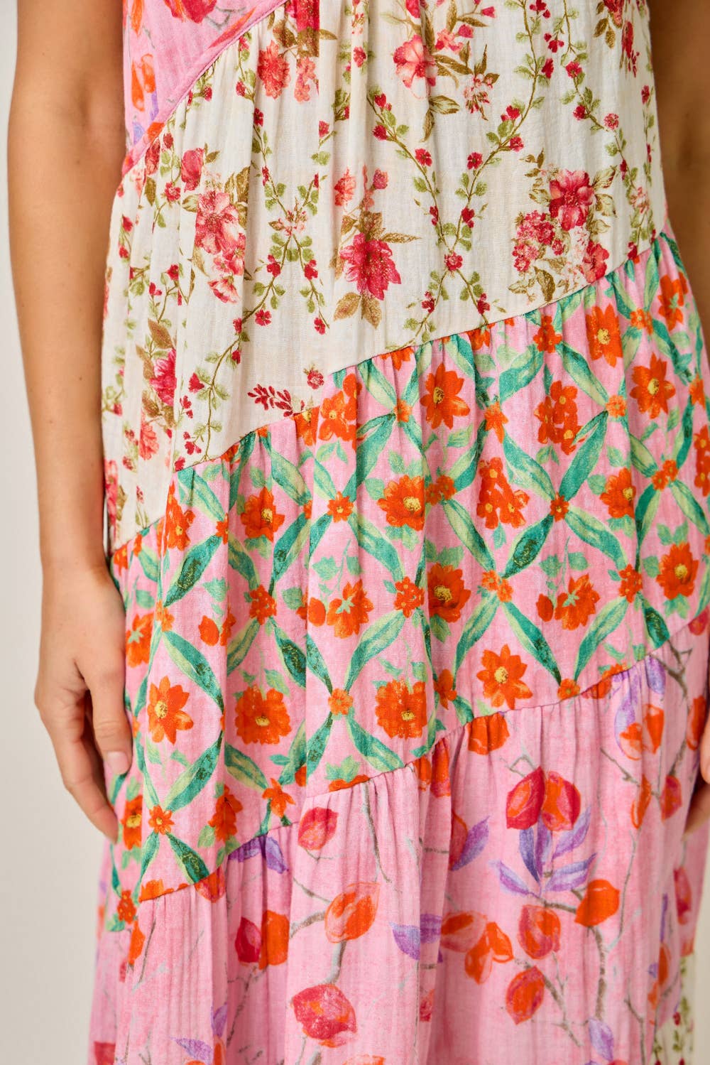 Multicolored floral dress with a mix of pink, orange, and green patterns.