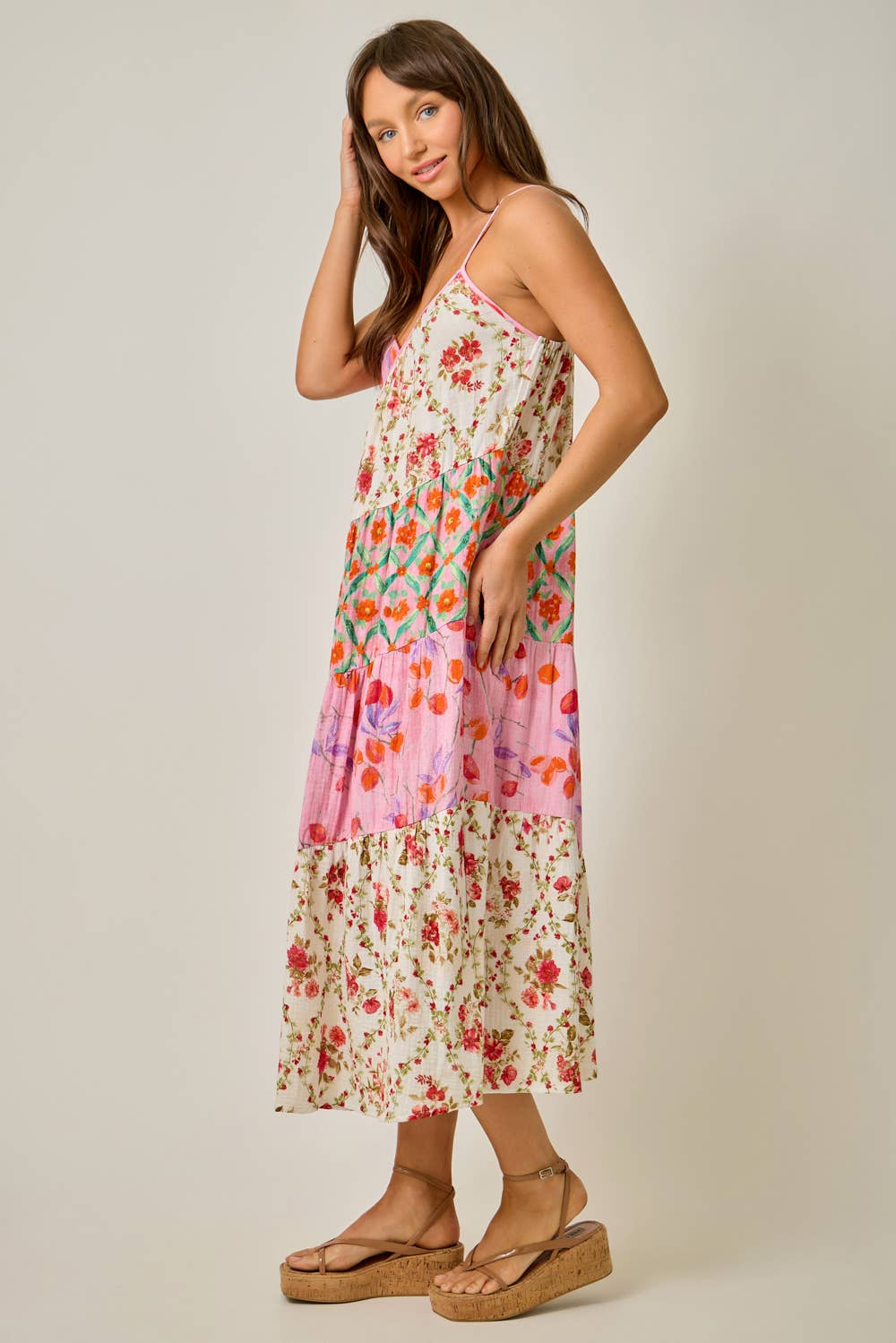 Woman wearing a floral dress with a plain background