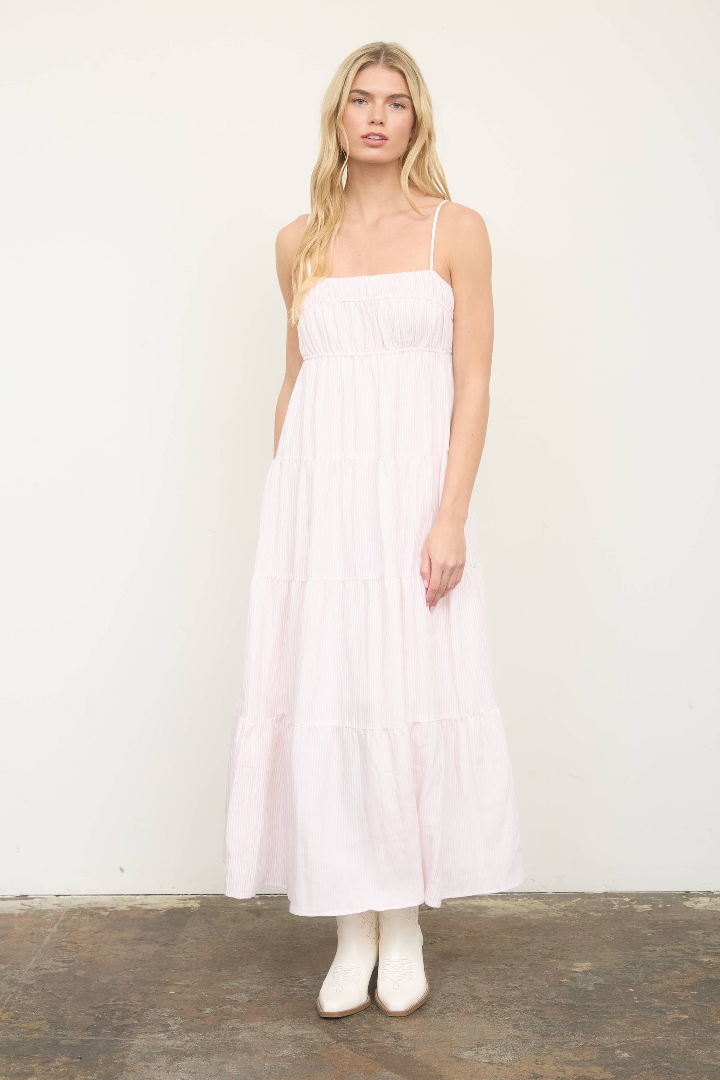 Woman wearing a white dress against a plain background