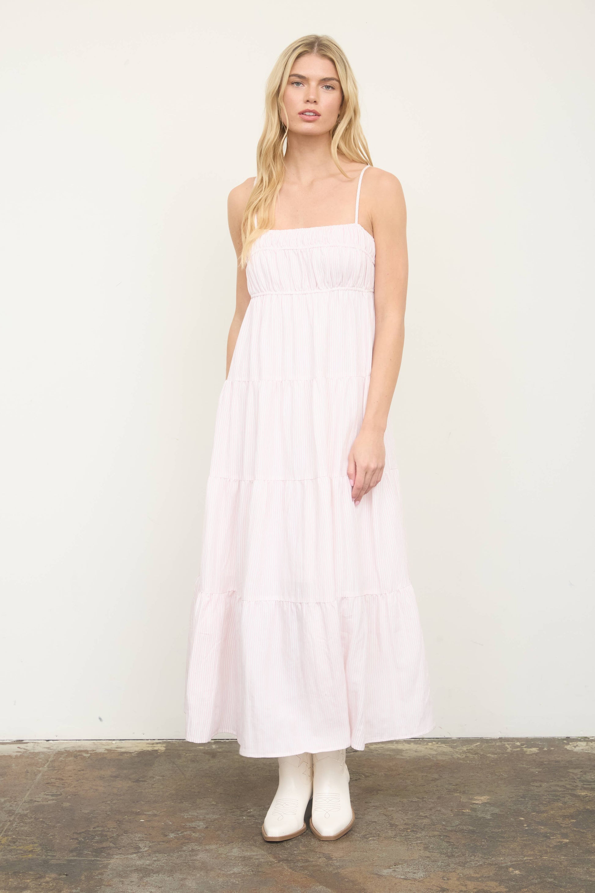 Woman wearing a white dress against a plain background